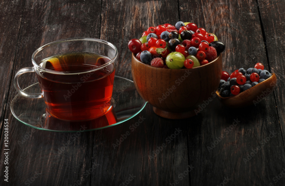 tea and berries on wooden background tea and berries on wooden background