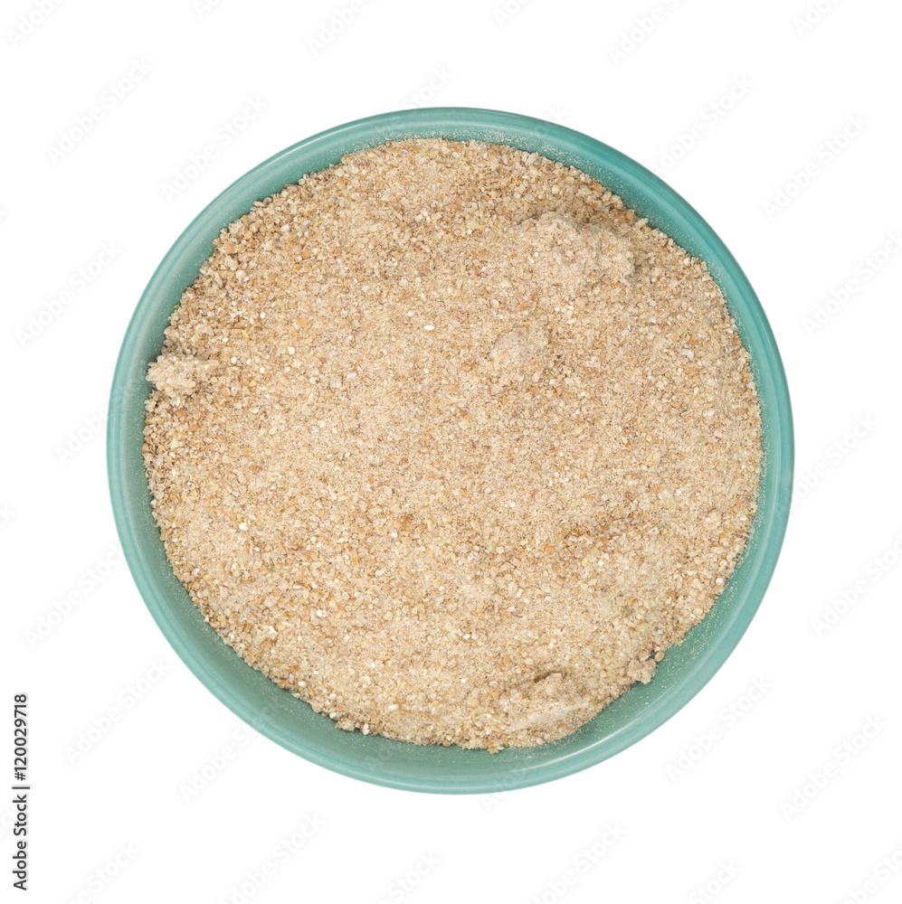 Bowl filled with stone ground whole wheat muffin mix on a white background. Bowl filled with stone ground whole wheat muffin mix on a white background.