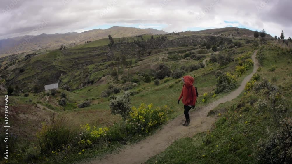 Woman using red hoodie walking over hiking path on the andean mountains. 4k Woman using red hoodie walking over hiking path on the andean mountains. 4k