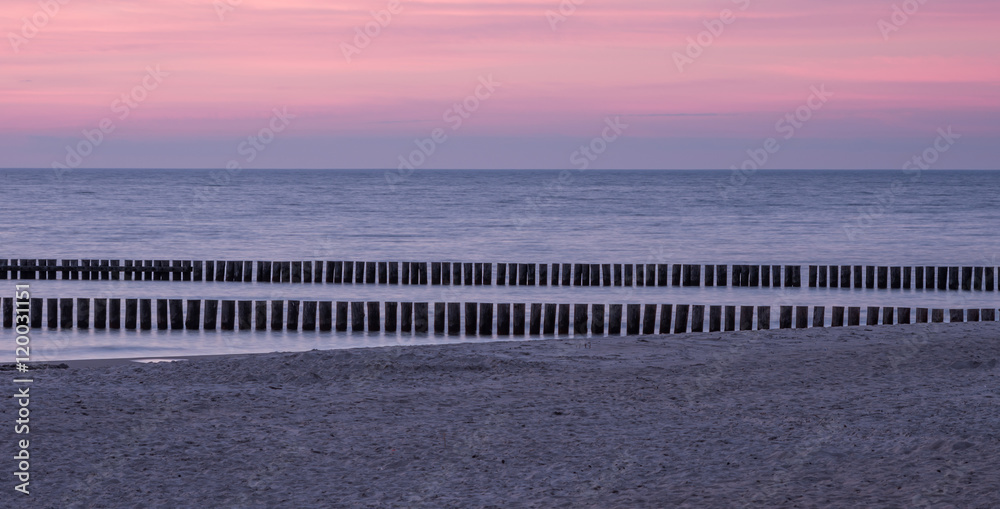 Wooden breakwaters - Baltic seascape at sunset, Poland