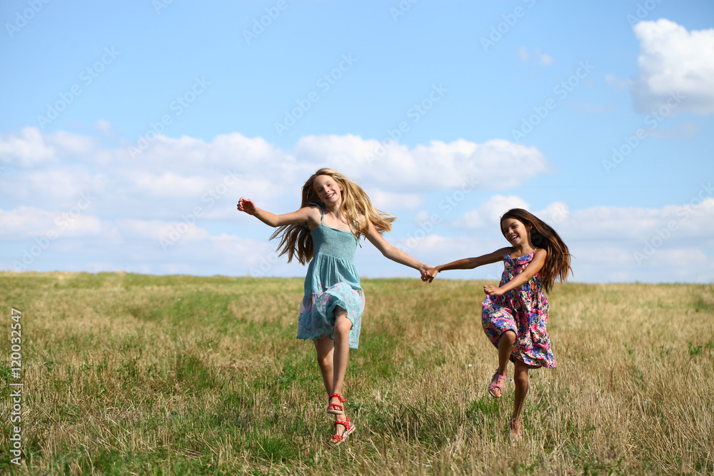 Two little girls running in summer field Two little girls running in summer field