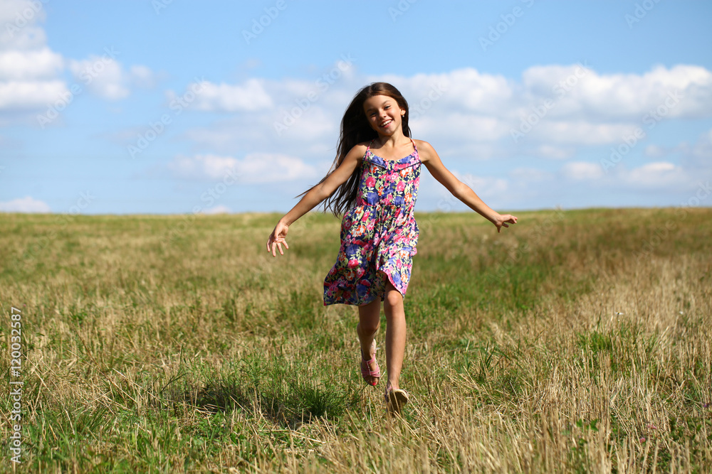 Beautiful young little girl running summer field Beautiful young little girl running summer field