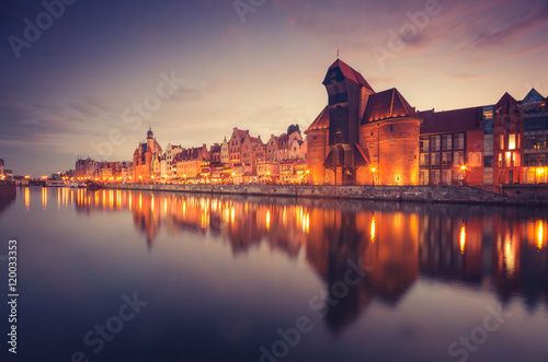 Gdansk old town with harbor and medieval crane in the evening.