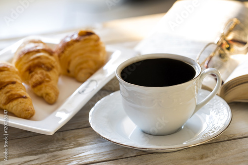 Croissants with coffee on the wooden table 