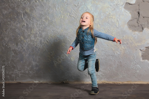 Cute little girl pretending to fly. Posing and playing.