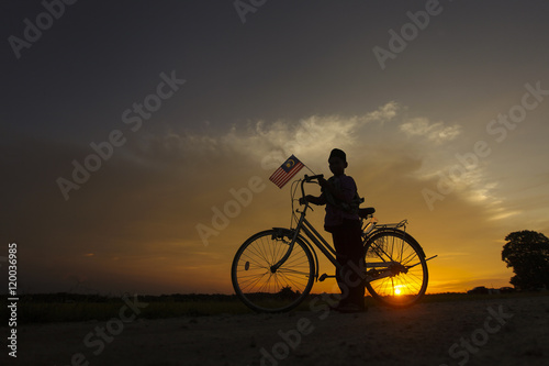 independence Day concept - Silhouette of young local boy on paddy field