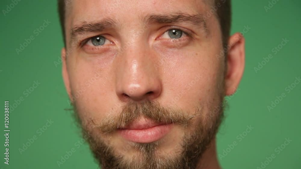 Close up man's face with trendy beard and mustache, green screen background Close up man's face with trendy beard and mustache, green screen background