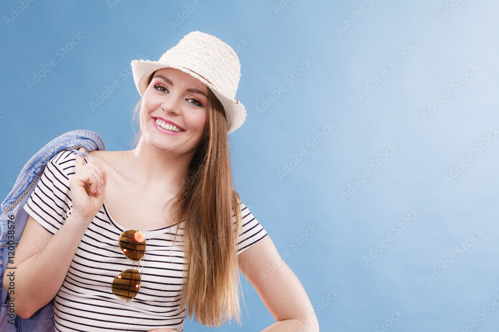 Happy cute tourist girl in straw hat.