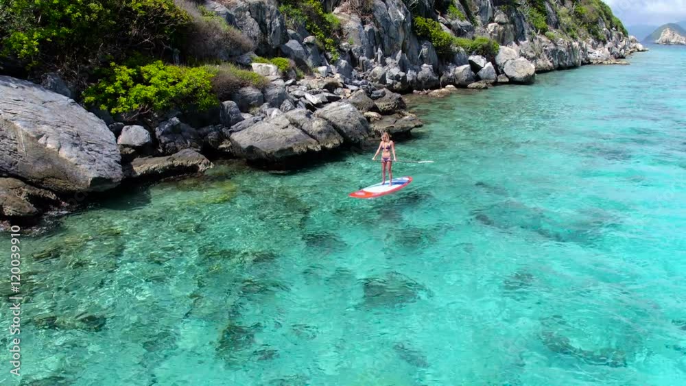 Bikini woman paddle boarding in the Caribbean, United States Virgin Islands
