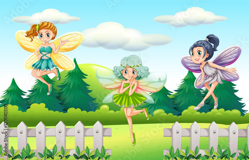 Three fairies flying in garden