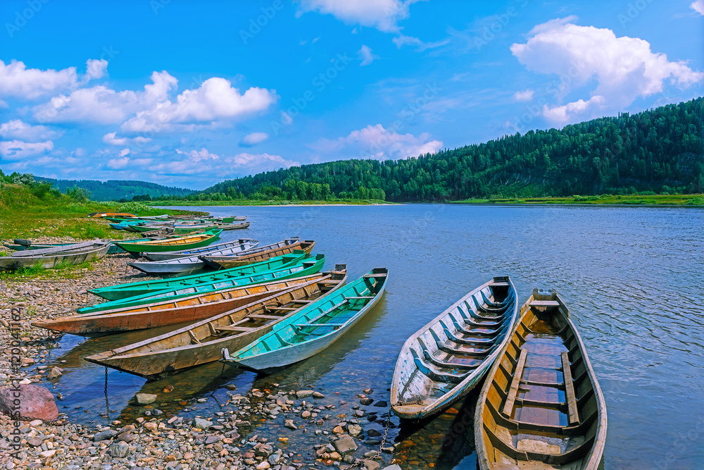 Wooden boats moored to the bank of the river