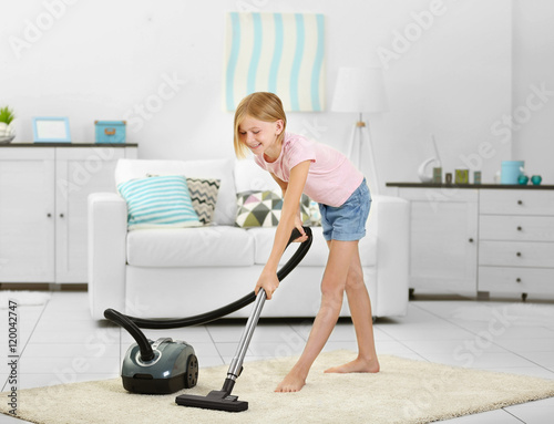 Little girl vacuuming floor...