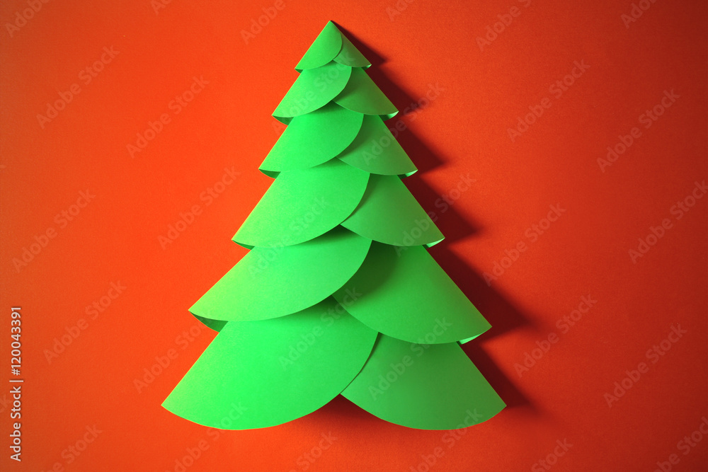 Christmas tree made of paper on color background Christmas tree made of paper on color background