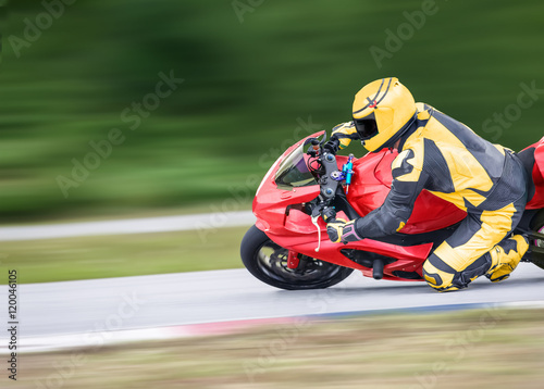 Motorcycle practice leaning into a fast corner on track