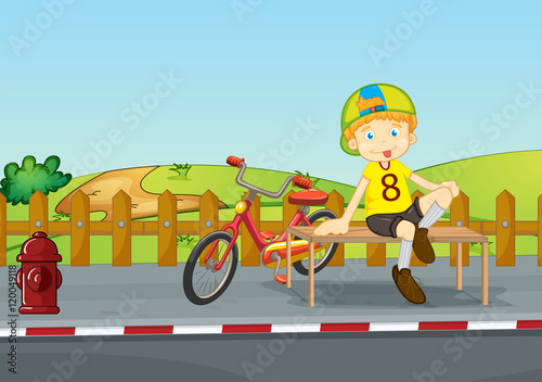Boy sitting on sidewalk