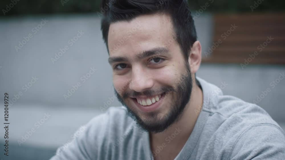 Portrait of Attractive Smiling Hispanic Ethnicity Young Man in Urban Environment. Shot on RED Cinema Camera in 4K (UHD). Portrait of Attractive Smiling Hispanic Ethnicity Young Man in Urban Environment. Shot on RED Cinema Camera in 4K (UHD).
