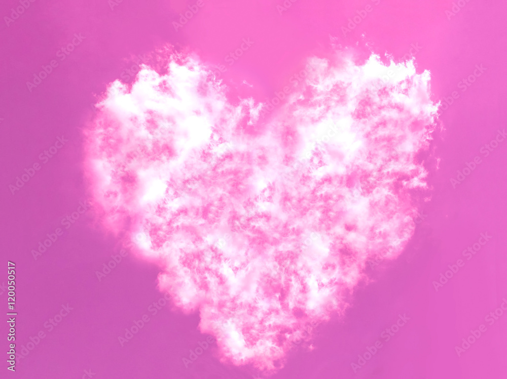 Heart shape white cloud on the pink sky.
