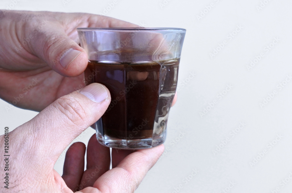 Man hands holds a black coffee cup Man hands holds a black coffee cup
