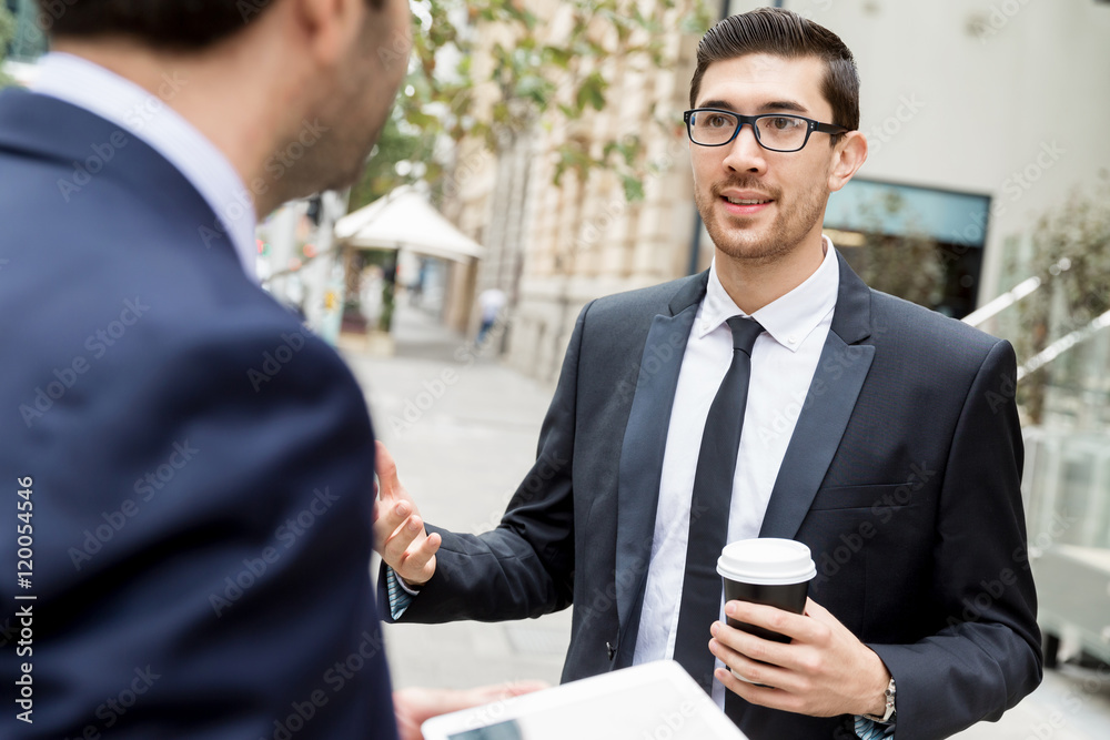 Fototapeta premium Two businessmen talking outdoors