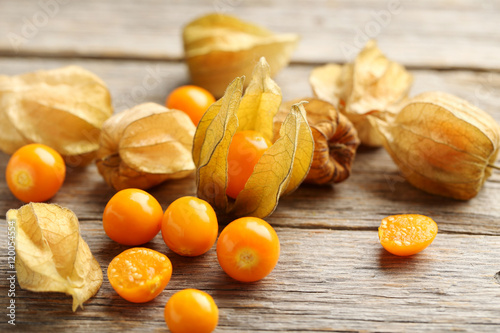 Ripe physalis on a grey wooden table photo