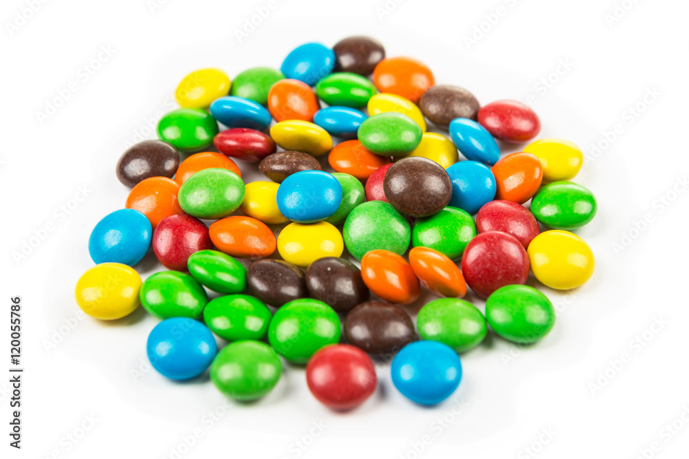 Mini multicolored chocolate pieces with a candy shell isolated on white background Mini multicolored chocolate pieces with a candy shell isolated on white background