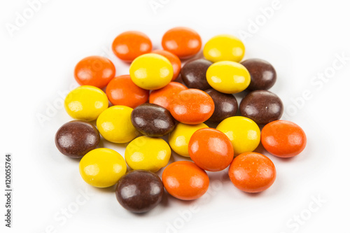 Multicolored peanut butter pieces with a candy shell isolated on white background