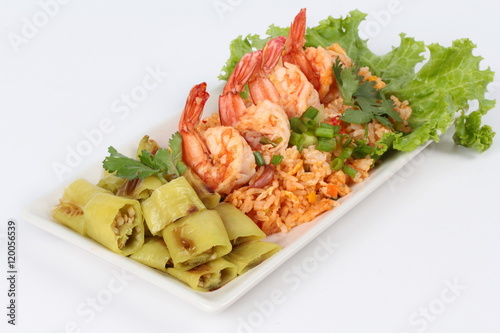 Fried rice with shrimp and grilled green sweet chili on white background. side view