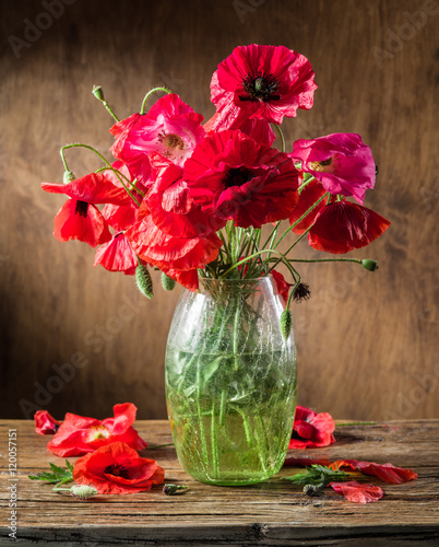 Fototapeta Naklejka Na Ścianę i Meble -  Bouquet of poppy flowers in the vase on the wooden table.