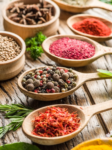 Fototapeta Naklejka Na Ścianę i Meble -  Assortment of colorful spices in the wooden spoons.