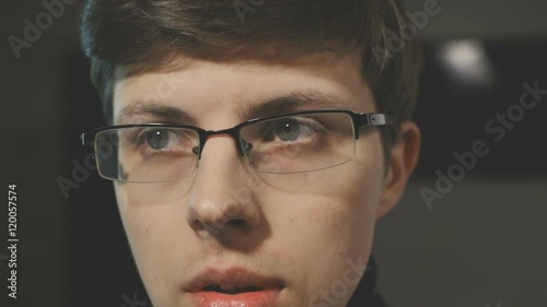 Portrait of worrying man with glasses. Looking right and left.