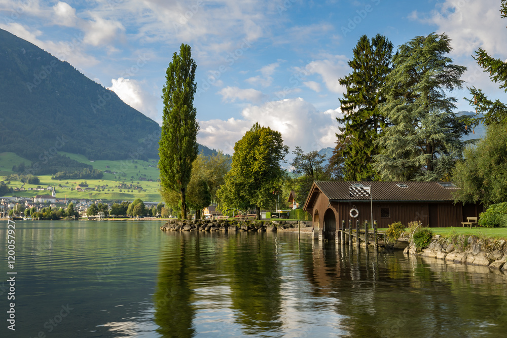 Picturesque wooden boat house on a lake shore