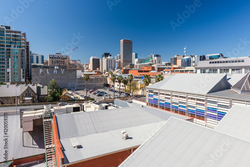 City downtown at sunny day with lots of building and roofs photo