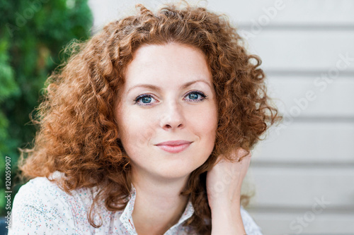 Beautiful girl portrait. Close-up face of happy young woman outdoors