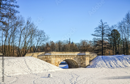 Gatchina, Leningrad oblast (Saint Petersburg suburbs), Russia. The Karpin bridge in the Palace Park of Gatchina Palace. Shot at a bright winter day.