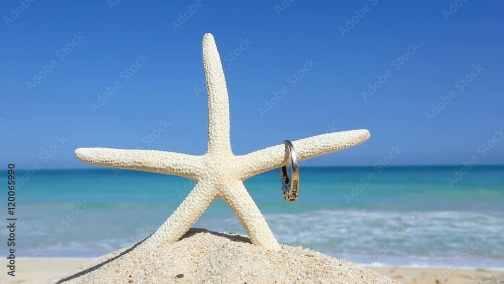 Love wedding concept Engagement ring and starfish on tropical beach Oahu Love wedding concept Engagement ring and starfish on tropical beach Oahu