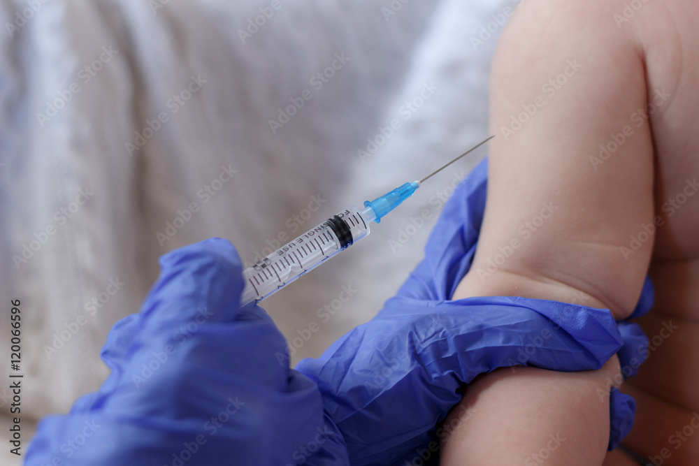 Doctor injecting a baby with a vaccination or antibiotic Doctor injecting a baby with a vaccination or antibiotic