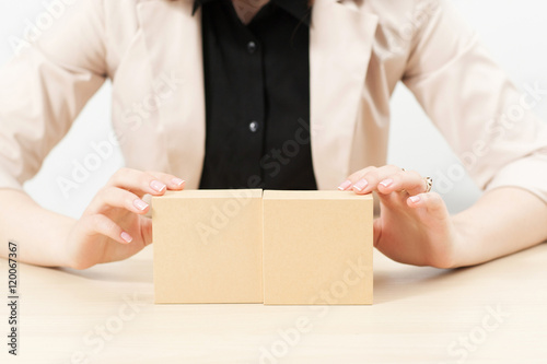 Unrecognizable woman showing boxes with pkg, copy space. Female hands holding two parcels with free space, great background for advertisement any product. Goods packaging, online shopping concept © golubovy