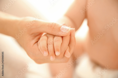 Mother holding baby hand  closeup