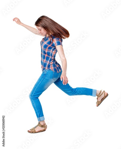 Balancing young woman. or dodge falling woman. Girl in plaid shirt jumping.