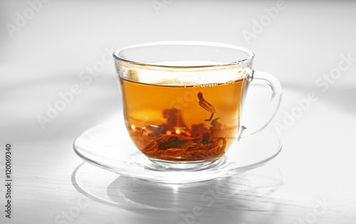 Glass cup of tea on table