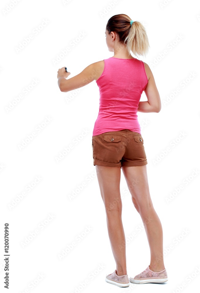 back view of writing beautiful woman. Isolated over white background. Sport blond in brown shorts writes on his back. back view of writing beautiful woman. Isolated over white background. Sport blond in brown shorts writes on his back.