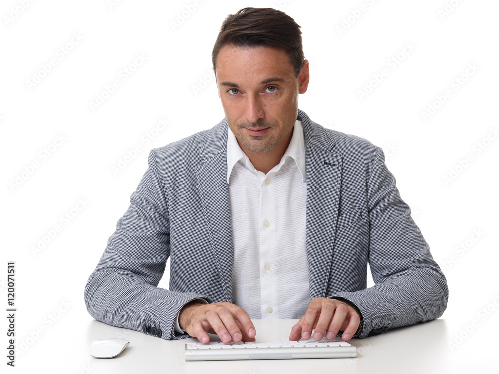 handsome businessman typing on keyboard. Isolated handsome businessman typing on keyboard. Isolated