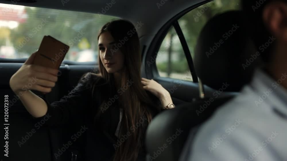 Beautiful woman tourist traveling in a taxi and make selfie for social networks Beautiful woman tourist traveling in a taxi and make selfie for social networks