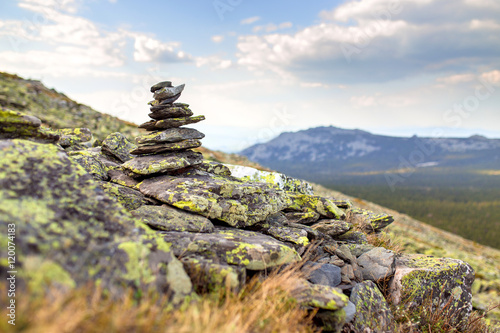 Canvas Print Granite stone cairn as a navigation mark on the top of mountain
