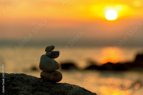 stone balance in sunrise
