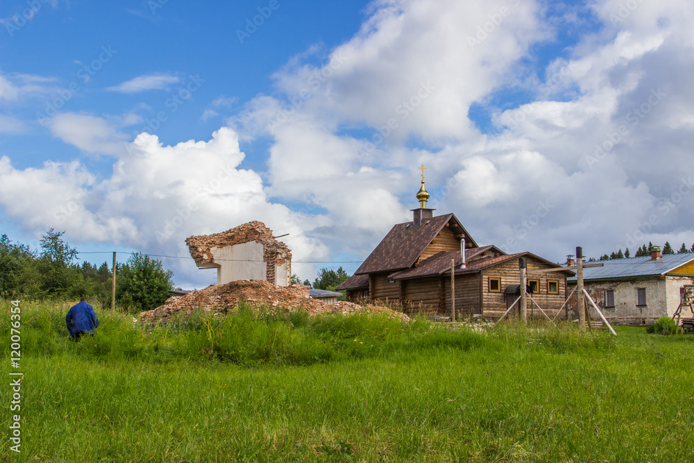 Ruined and modern church in Kornilie-Paleostrovsky monastery on Paliy island, Onega lake, Karelia, Russia