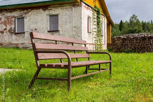 Complex of Kornilie-Paleostrovsky monastery on Paliy island, Onega lake, Karelia, Russia. Focus on bench