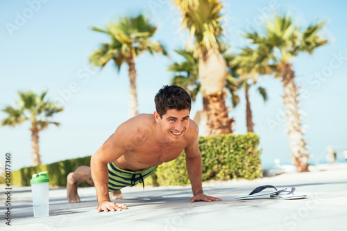 Doing push ups on the beach