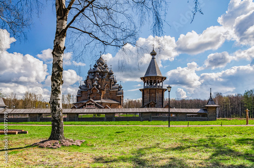 Saint Petersburg suburbs, Russia. Bogoslovka manor complex. The Pokrovskaya church and the bellfry behind the birch tree at the Easter day. photo