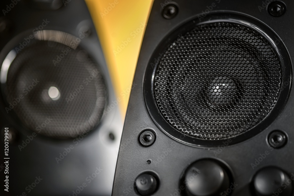 Audio speakers on yellow background